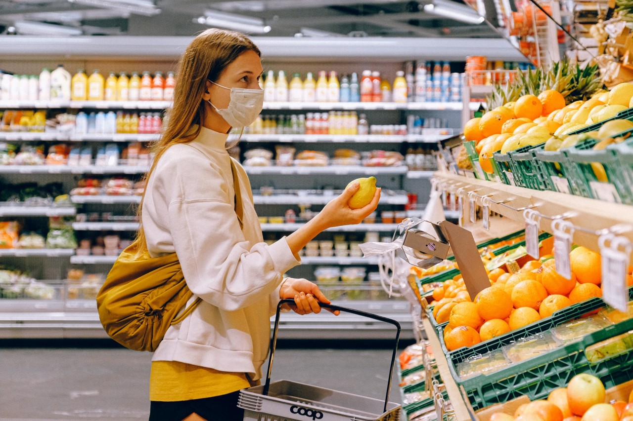 woman-in-yellow-tshirt-and-beige-jacket-holding-a-fruit-3962285